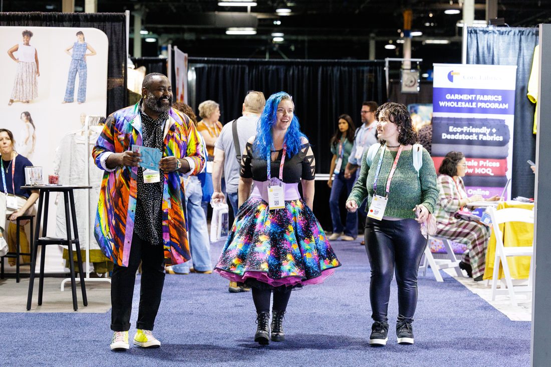 An attendee in a handmade crochet outfit holding yarn