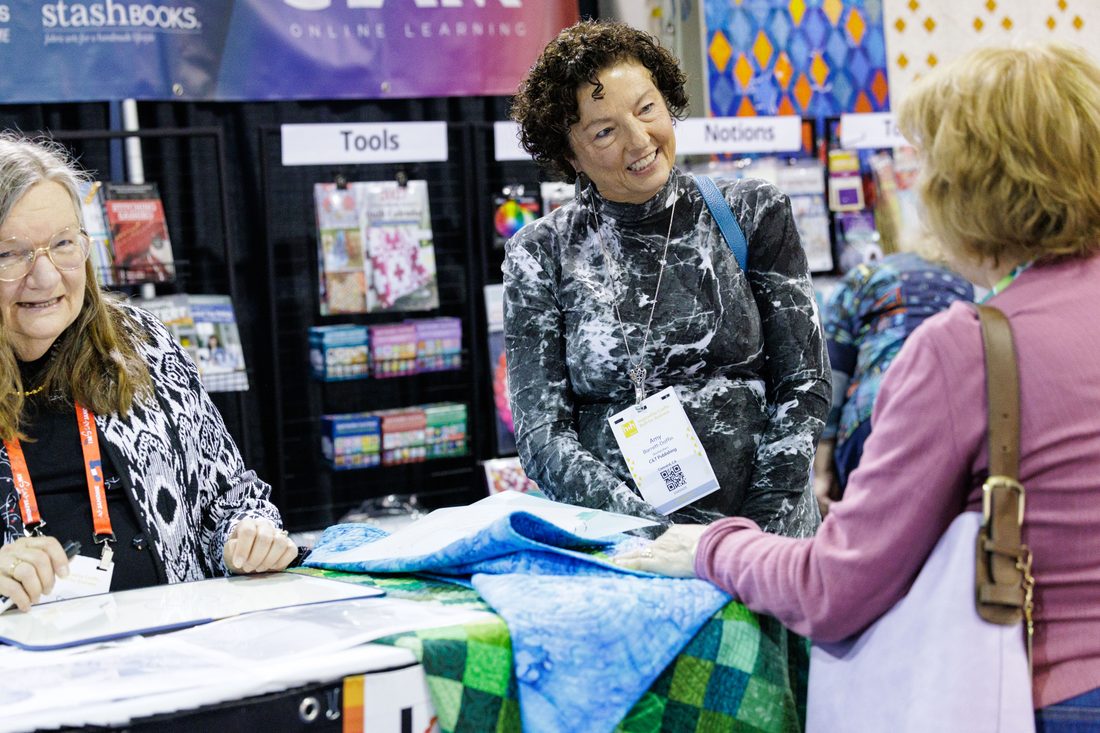 Buyers and exhibitors talking business at a booth